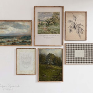 May include: A gallery wall arrangement featuring six framed art prints. The collection includes landscape paintings, botanical drawings, and text-based pieces, all presented in wooden frames. The artwork is displayed on a white wall.