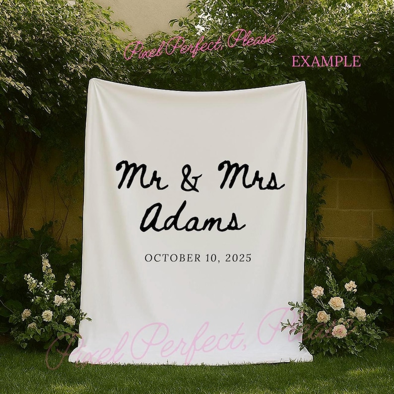 mockup of a white tapestry banner hanging near some trees and neuatful ivory flowers perfect to use for mockups that are selling tapestry backdrops or signs for weddings, bachelorette trips or bridal showers