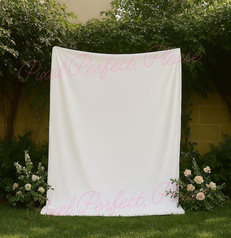 mockup of a white tapestry banner hanging near some trees and neuatful ivory flowers perfect to use for mockups that are selling tapestry backdrops or signs for weddings, bachelorette trips or bridal showers