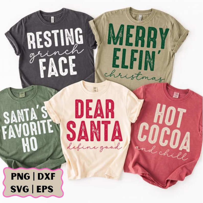 May include: Five t-shirts with Christmas-themed text. The shirts are in various colors: charcoal, olive green, tan, cream, and red. The text includes phrases like "Resting Grinch Face," "Merry Elfin' Christmas," and "Dear Santa define good."