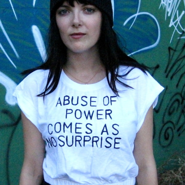 Abuse of Power Comes as No Surprise - Black Text on White Crop Top