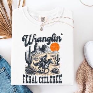 Comfort Colors® Retro Wranglin&#39; Feral Children Raccoon Shirt, 90s Western Desert Tee, Vintage Cowboy Raccoon Shirt, Funny Cool Teen Gift
