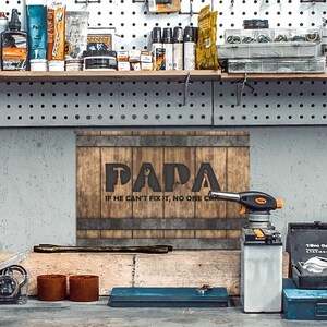 Each letter in the bold word PAPA includes the silhouette of a hand tool as part of the letter.  Beneath the word PAPA is the phrase “If he can’t fix it, no one can.” The background looks like aged vertical boards similar to a flattened oak barrel. At the top and bottom are aged metal strips. This is a perfect gift for anyone’s husband, dad, stepdad, grandpa, or favorite male friend who has tools and knows who to fix things. NOTE: This is a flat metal sign, not real wood or metal.