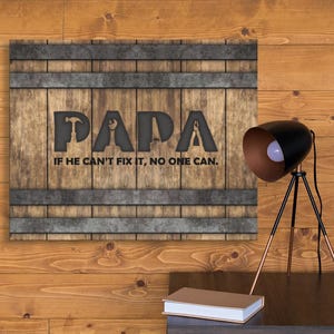 Each letter in the bold word PAPA includes the silhouette of a hand tool as part of the letter.  Beneath the word PAPA is the phrase “If he can’t fix it, no one can.” The background looks like aged vertical boards similar to a flattened oak barrel. At the top and bottom are aged metal strips. This is a perfect gift for anyone’s husband, dad, stepdad, grandpa, or favorite male friend who has tools and knows who to fix things. NOTE: This is a flat metal sign, not real wood or metal.