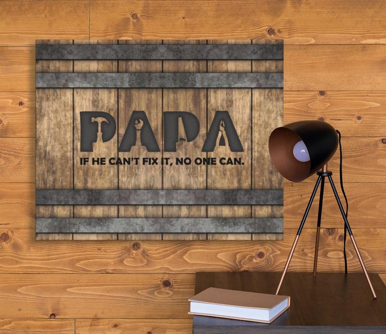 Each letter in the bold word PAPA includes the silhouette of a hand tool as part of the letter.  Beneath the word PAPA is the phrase “If he can’t fix it, no one can.” The background looks like aged vertical boards similar to a flattened oak barrel. At the top and bottom are aged metal strips. This is a perfect gift for anyone’s husband, dad, stepdad, grandpa, or favorite male friend who has tools and knows who to fix things. NOTE: This is a flat metal sign, not real wood or metal.