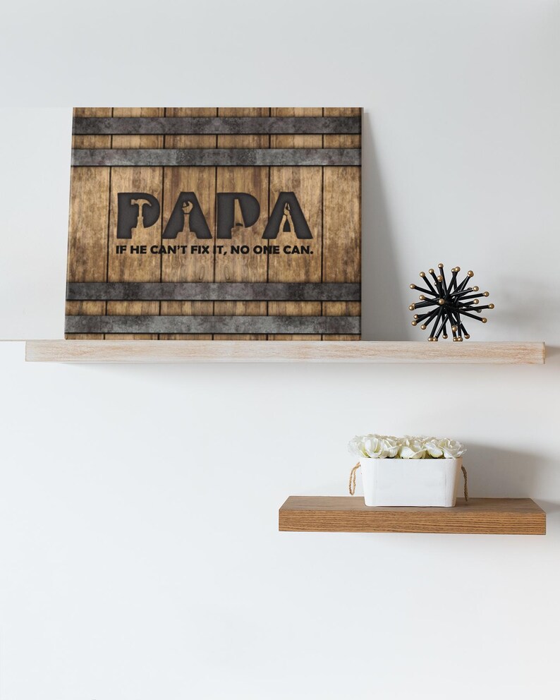 Each letter in the bold word PAPA includes the silhouette of a hand tool as part of the letter.  Beneath the word PAPA is the phrase “If he can’t fix it, no one can.” The background looks like aged vertical boards similar to a flattened oak barrel. At the top and bottom are aged metal strips. This is a perfect gift for anyone’s husband, dad, stepdad, grandpa, or favorite male friend who has tools and knows who to fix things. NOTE: This is a flat metal sign, not real wood or metal.
