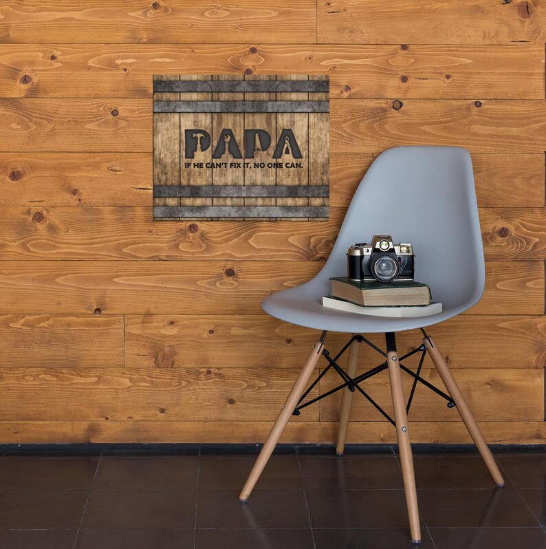 Each letter in the bold word PAPA includes the silhouette of a hand tool as part of the letter.  Beneath the word PAPA is the phrase “If he can’t fix it, no one can.” The background looks like aged vertical boards similar to a flattened oak barrel. At the top and bottom are aged metal strips. This is a perfect gift for anyone’s husband, dad, stepdad, grandpa, or favorite male friend who has tools and knows who to fix things. NOTE: This is a flat metal sign, not real wood or metal.