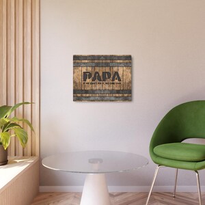 Each letter in the bold word PAPA includes the silhouette of a hand tool as part of the letter.  Beneath the word PAPA is the phrase “If he can’t fix it, no one can.” The background looks like aged vertical boards similar to a flattened oak barrel. At the top and bottom are aged metal strips. This is a perfect gift for anyone’s husband, dad, stepdad, grandpa, or favorite male friend who has tools and knows who to fix things. NOTE: This is a flat metal sign, not real wood or metal.