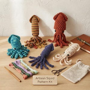 May include: A crochet kit featuring five handmade squid plushies in teal, striped, rust, purple, and cream colors, accompanied by embroidery floss, a wooden crochet hook, metal scissors, and a small drawstring bag with an Artisan Squid Pattern Kit sign.