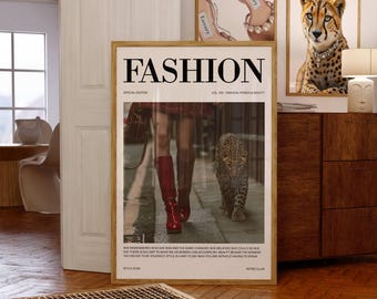 May include: A framed "FASHION" poster with a woman in red boots and a leopard. Two other framed posters read "FEMME FATALE" and "THE NEW GLAM". The posters are displayed in a room with wooden furniture and a table.