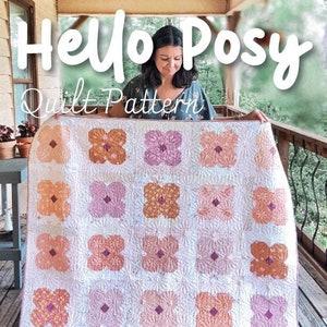 May include: A quilt pattern called "Hello Posy" by Melanie Traylor. The pattern is for a quilt with a floral design in shades of pink, orange, and white. The quilt is shown in three sizes: 35 inches by 48 inches, 60 inches by 60 inches, and 84 inches by 96 inches. The pattern is described as "Beginner".