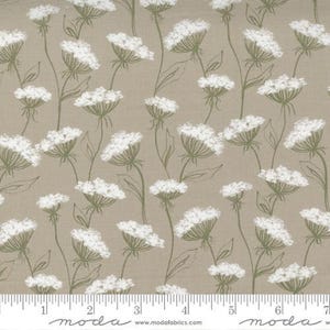 May include: Fabric with a repeating pattern of white flower clusters and green stems on a tan background. The flowers have a textured appearance, and the stems are thin and delicate. The fabric is suitable for quilting, sewing, and other craft projects.