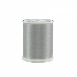 May include: A spool of silver thread for sewing or embroidery.