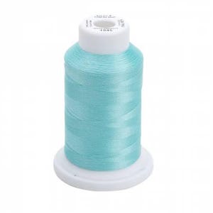 May include: A spool of light blue thread with a white label that reads "Made in USA  100% Polyester  4045  Made with Pride".