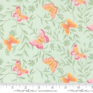 May include: Light green fabric with a repeating pattern of butterflies and foliage. The butterflies have pink and orange wings, and the leaves are a muted green. The fabric has a ruler along the bottom with the word "moda" printed on it.