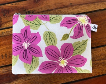 Purple clematis flowers on pale grey, medium sized flat, cotton zipper pouch