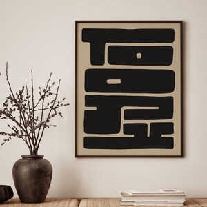 Minimalist art print featuring the word “TOKYO” spelled out horizontally “TO” and vertically “KYO” in a bold, black font against a soft, neutral beige background.