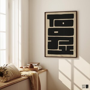 Graphic art print of “TOKYO” in black letters on a beige background.