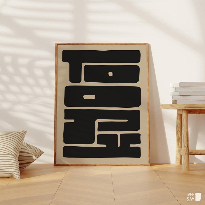 Minimalist art print featuring the word “TOKYO” spelled out horizontally “TO” and vertically “KYO” in a bold, black font against a soft, neutral beige background.