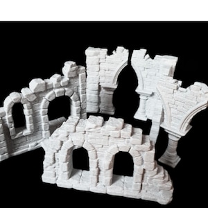 May include: Set of four white plaster ruined castle wall sections with arched openings. The sections are designed for tabletop gaming and miniature wargaming.
