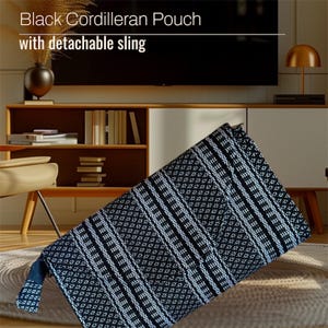 May include: Black and white woven pouch with a geometric pattern. The pouch has a detachable sling.