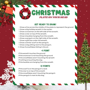 May include: A festive Christmas-themed game board with instructions and scoring details. The board features a wreath, snowman, star, baubles, penguin, gift box, scarf, dog, and snowflakes. The text "CHRISTMAS PLATE ON YOUR HEAD" is displayed at the top.