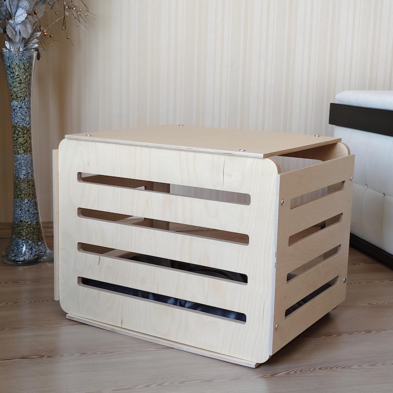 Wooden indoor dog crate designed for home use, displayed in a living room to show size and furniture-style design.