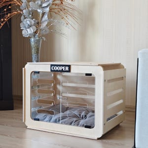 Side angle of a wooden dog crate furniture highlighting ventilation slots, smooth rounded edges, and solid birch plywood construction.