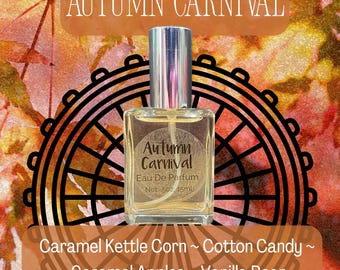 May include: A clear glass perfume bottle with a silver cap, labeled Autumn Carnival Eau De Parfum Net .5oz 15ml. The bottle is centered over a black graphic of a Ferris wheel against an orange and red autumn leaf background with text listing Caramel Kettle Corn, Cotton Candy, Caramel Apples, and Vanilla Bean.