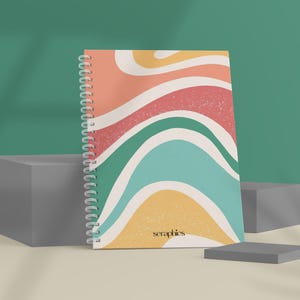 May include: Spiral-bound notebook with a colorful abstract design. The cover features wavy stripes in shades of peach, red, green, teal, and yellow. The word "seraphics" is printed in black at the bottom right corner.