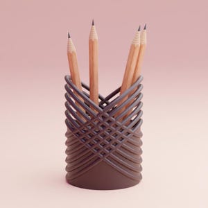 May include: A brown pencil holder made of woven plastic with four wooden pencils inside.