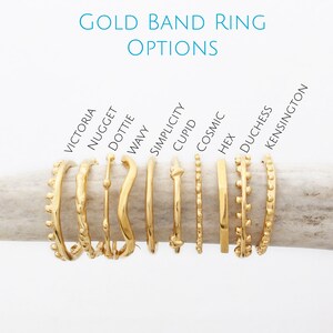 May include: Ten gold band rings with different designs, including a wavy ring, a ring with a knot, and a ring with a row of small beads. The rings are labeled with names like "Victoria", "Nugget", "Dottie", "Wavy", "Simplicity", "Cupid", "Cosmic", "Hex", "Duchess", and "Kensington".
