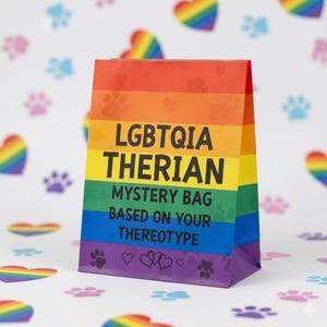 Op de afbeelding: Een kleurrijke papieren cadeauzak met de tekst "LGBTQIA THERIAN MYSTERY BAG BASED ON YOUR THEREOYTYPE". De zak heeft een regenboogontwerp met pootafdrukken en harten.
