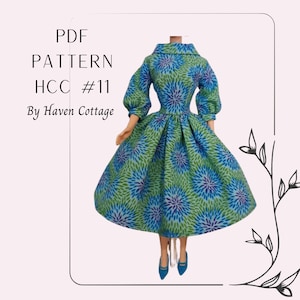 May include: PDF pattern for a doll dress, HCC #11 by Haven Cottage. The dress is green and blue with a floral print.