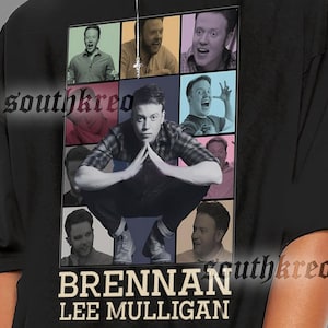 May include: Black t-shirt featuring a collage of images of Brennan Lee Mulligan. The shirt has the text "BRENNAN LEE MULLIGAN" printed in white. The model is wearing black sunglasses and hoop earrings.