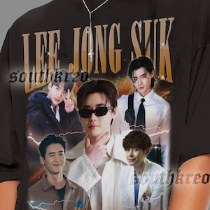 May include: Black oversized t-shirt featuring a collage of images and the text "LEE JONG SUK" in gold lettering. The shirt has a vintage aesthetic with a faded look and a crew neck.