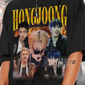 May include: Black t-shirt featuring the name "HONGJOONG" in gold lettering, with a collage of images of a musical group. The shirt is worn by a person wearing sunglasses and hoop earrings.