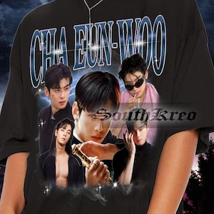 May include: Black oversized t-shirt featuring a graphic print of a group of men. The print includes the text "CHA EUN-WOO" in a blue and white font. The t-shirt is being worn by a person with dark hair and sunglasses.