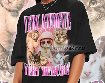May include: Black t-shirt with a pink graphic print of cats and the text "Very Mindful Very Demure".