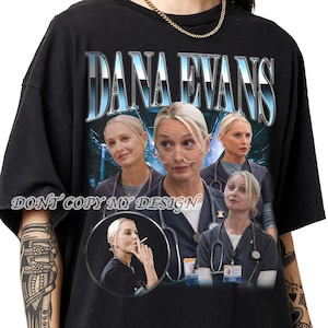 May include: Black t-shirt featuring a graphic of Dana Evans with the name in a blue and white font. The design includes multiple images of the person in a medical setting. The text "DONT COPY MY DESIGN" is printed at the bottom.
