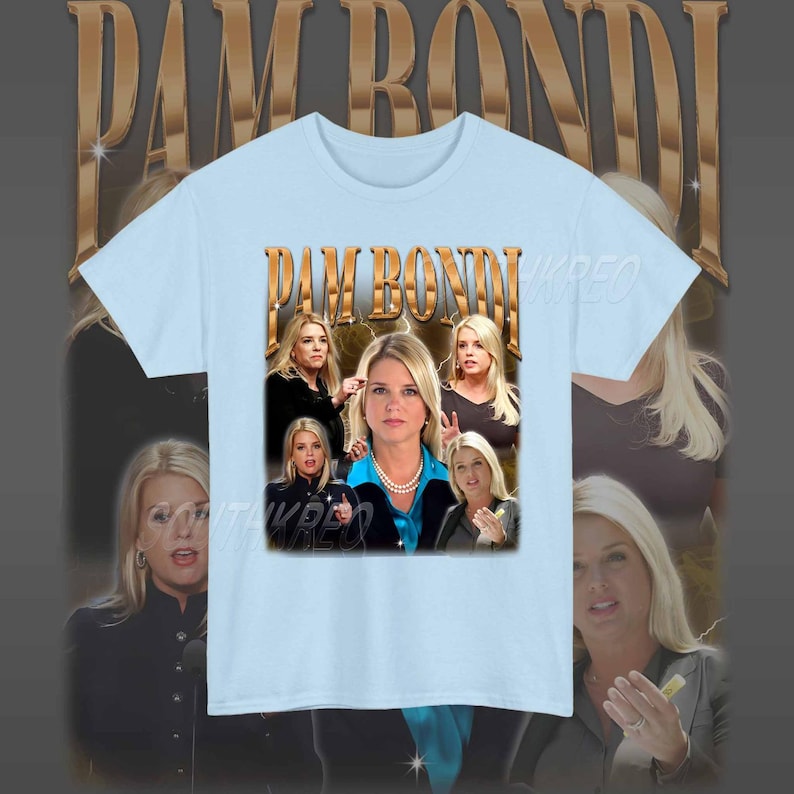 May include: Light blue t-shirt with a graphic print of Pam Bondi, a former Florida Attorney General. The graphic features multiple images of Bondi in different poses, with the text "PAM BONDI" in gold letters.
