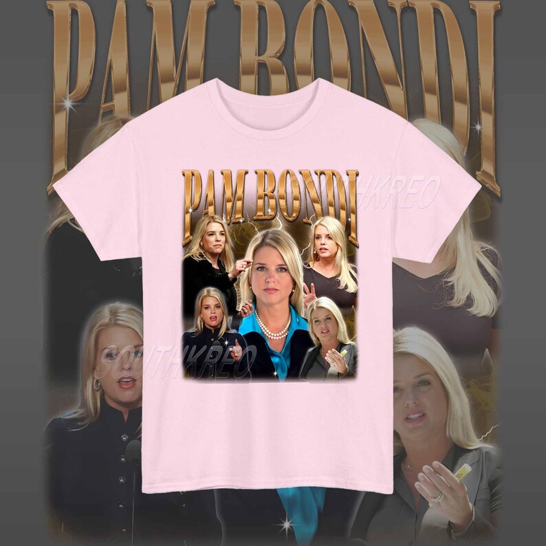 May include: Pink t-shirt with a graphic print of Pam Bondi, a former Florida Attorney General. The graphic features multiple images of Bondi in different poses and settings. The text "PAM BONDI" is printed in gold letters across the top of the graphic.