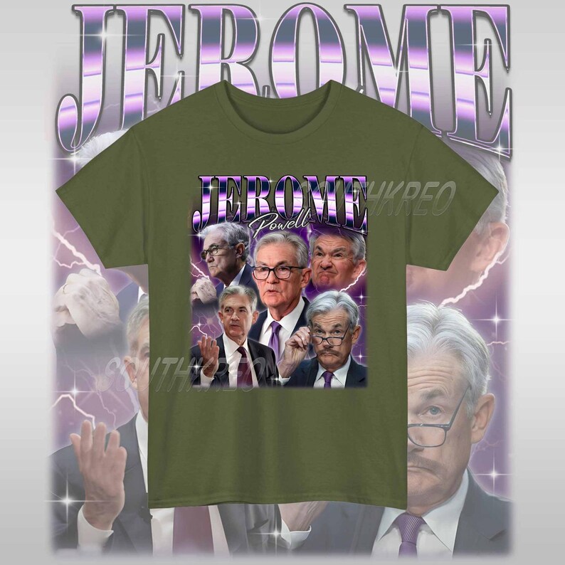 May include: A green t-shirt with a graphic print of Jerome Powell, the chairman of the Federal Reserve, surrounded by other men. The text "Jerome Powell" is printed in purple above the image. The background is a purple and white lightning bolt pattern.
