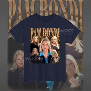 May include: A navy blue t-shirt with a graphic print of Pam Bondi, a former Florida Attorney General. The graphic features multiple images of Bondi in a collage style with the text "Pam Bondi" in gold letters.