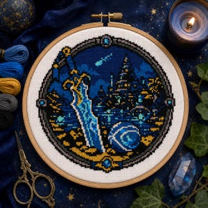 May include: A circular cross-stitch embroidery in a wooden hoop featuring a fantasy scene with a large sword, a glowing blue orb, and a distant castle silhouette against a dark blue night sky with a shooting star, all framed by a decorative border.
