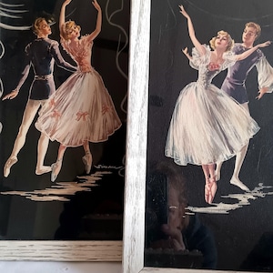May include: Two framed vintage art prints featuring ballet dancers in motion. The dancers are depicted in a classic style, with the figures in elegant poses against a black background. The frames are white.
