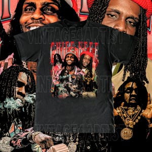 May include: Black t-shirt featuring a graphic of Chief Keef with the text "Chief Keef" in red and white. The shirt has a vintage design with multiple images of the artist and the words "VINTAGE4ARTIST" printed on the shirt.