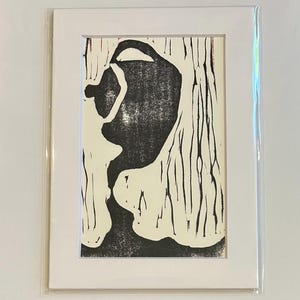 May include: Black and white abstract print of a figure with a textured background. The figure is in the shape of a person with a large head and a small body.