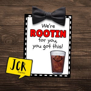 May include: A white card with black and white dashed borders and a black bow tie at the top. The card says "We're ROOTIN for you, you got this!" and has a cartoon image of a glass of cola with a smiley face.