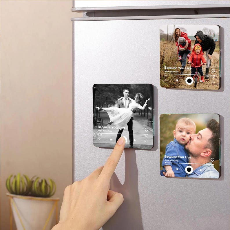 May include: Three square magnets with family photos and music player interfaces. One shows a couple dancing, another a family walking, and the third a father kissing a baby. The text "Because You Live" is visible on each.